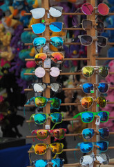 Obraz premium Racks of colorful sunglasses for sale at a state fair