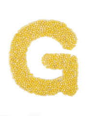 Letter G of the English alphabet made from millet on an isolated background.