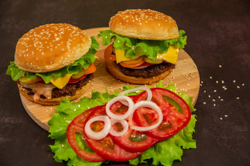 Hamburger or Cheeseburger on black background. Fast food. Two burger.