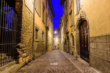 Fototapeta na wymiar Night view of the medieval streets in the historical center of Bergamo, Italy