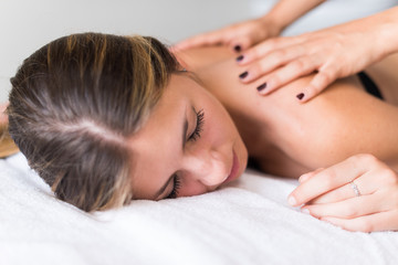 Obraz na płótnie Canvas Woman having a massage in a spa