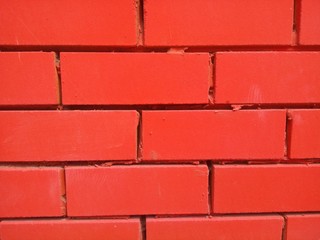 brick wall painted red close-up © Евгений Арефьев