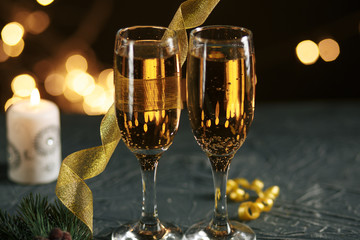 selective focus of glasses full of champagne against christmas lights