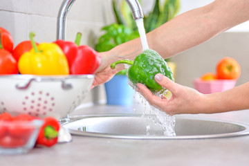 Washing vegetables. A woman in the kitchen.