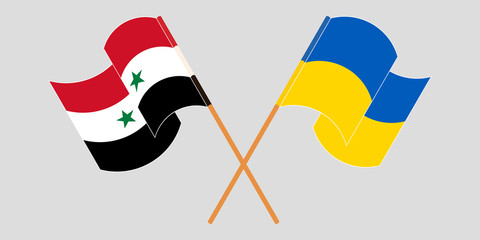 Crossed and waving flags of Syria and the Ukraine