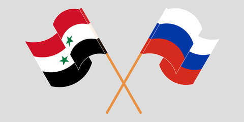 Crossed and waving flags of Syria and Russia