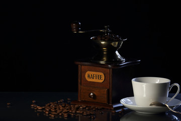 coffee grinder, cup and coffee beans