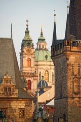 Fototapeta premium St. Nicholas Church and Charles Bridge Tower, Mala Strana, Prague