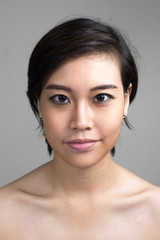 Portrait of young beautiful Asian woman with short hair shirtless