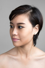 Portrait of young beautiful Asian woman with short hair shirtless
