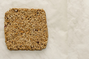 Homemade oat and peanut protein bar, compound cooked before cutting into portions. Image with space for text.