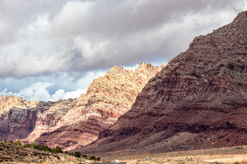 Dark clouds gather through the sun near rolling mountains in AZ, USA