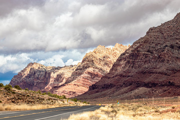 The highway hugs the rolling hills in the wilderness of AZ, USA