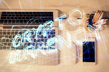 Blockchain theme hologram drawings over computer on the desktop background. Top view. Multi...