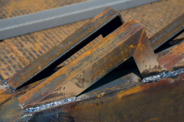 Welded Metal details. A blank steel part. Welding work at a construction site. Welding seam close-up.