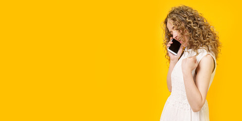 Portrait of a young woman who is emotionally talking on the phone. Female portrait.