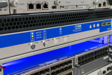 Computer hardware works in the server room. The technical platform of the Internet provider. Server equipment is configured in a modern data center
