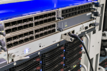 Computer equipment works in the server room of the data center. Front panel of powerful routers
