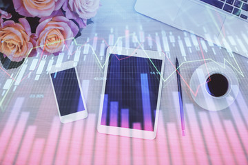 Double exposure of forex graph hologram over desktop with phone. Top view. Mobile trade platform concept.