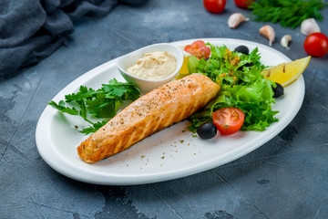 Salmon steak on the grill with sause tartar