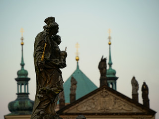 Fototapeta na wymiar Statue on Charles Bridge, Prague - view towards the Old Town