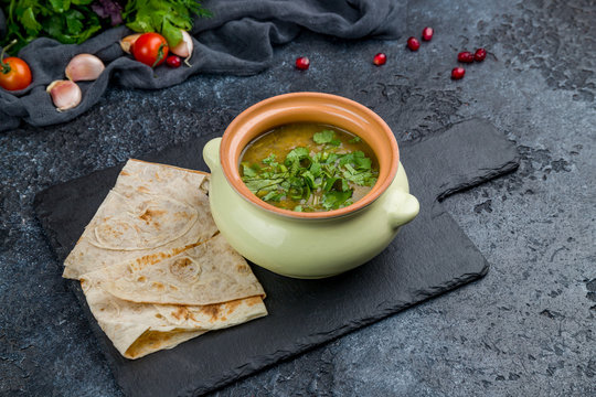 Aveluk soup Armenian cuisine on black stone table