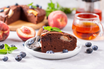 Piece of homemade chocolate cake with peaches