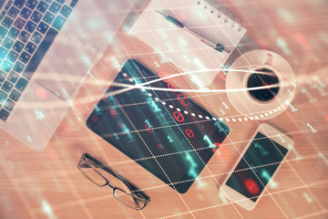 Double exposure of financial graph hologram over desktop with phone. Top view. Mobile trade platform concept.
