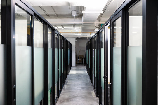 Corridor with glass door partition in modern office