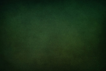 Texture for artwork and photography. Abstract dark green stained paper texture background or backdrop.