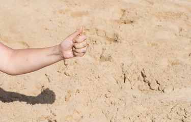 Sand falling from a woman's hand
