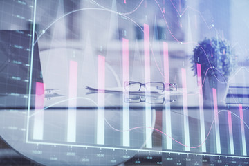 Double exposure of financial graph drawing and office interior background. Concept of stock market.