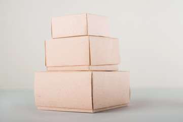 Cardboard boxes on a white background. Ecological packaging of paper products close-up and copy space. Craft containers, packaging, boxes, packages.