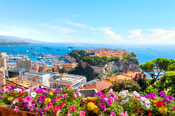 Obraz premium View of the city of Monte Carlo including the Rock, marina, Mediterranean Sea and cityscape along the coast of Monaco, on the French Riviera
