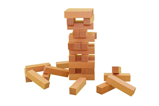 Ruined tower made of brown rectangular bars. Board game Jenga Tower made of wooden blocks. A game of skill, logic and coordination. Balance. Close-up. Isolation on a white background.