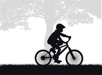 Naklejka na ściany i meble Silhouette of a child on a bike.