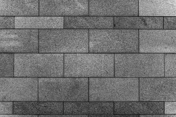 Texture of granite tiles. Black and white photo of a stone wall.