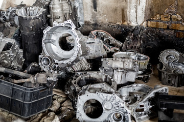 Old transmission transfer cases coated with oil and rust in a car workshop. Restoration, tuning and...