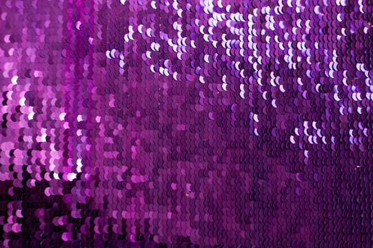 Glamor lilac Background with Sequins close-up. Abstract Texture scales with shiny sequins on fabric.