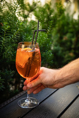 orange alcoholic drink Aperol in glasses with ice. Stand on a table in the backyard
