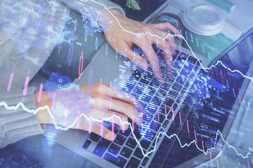 Double exposure of woman hands typing on computer and forex chart hologram drawing. Stock market invest concept.