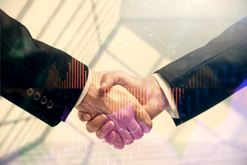 Double exposure of forex graph hologram and handshake of two men. Stock market concept.