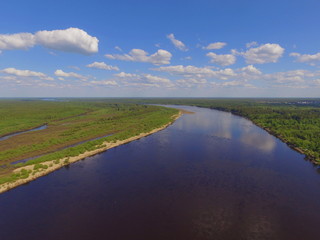 Bend of the Vychegda river and blue sky with clouds, Komi Republic, Russia.