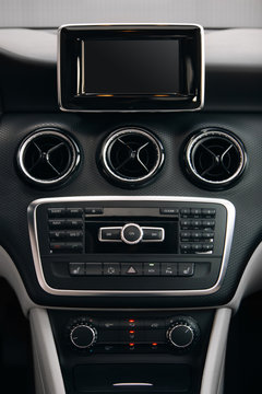 Modern car interior with dashboard and large monitor screen. Vertical photo