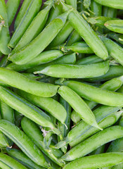 fresh green peas on wooden surface