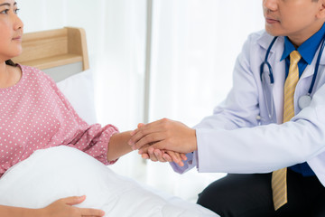 Close up of man doctor touching patient hand for encouragement and empathy on the hospital, cheering and support patient, Bad news, medical examination, trust and ethics.