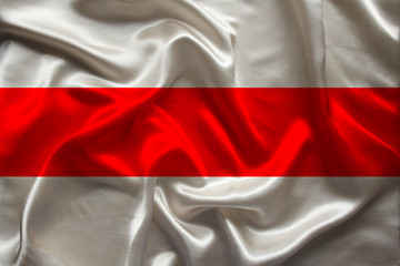 beautiful photo of a colored national flag of the modern state of Belarus on a textured fabric, concept of tourism, emigration, economy and politics, closeup