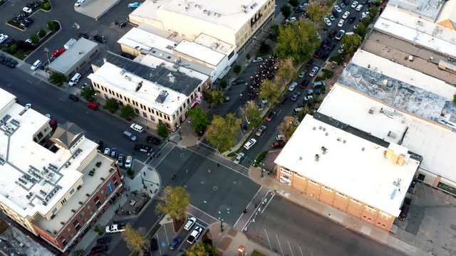 Provo, Utah / USA - July 1st 2020: Circling aerial drone shot of Pro Trump protestors walking in the middle of center street after a shooting at a Black Lives Matter Protest the day before.
