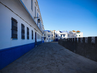 Fototapeta na wymiar Empty street in the white city of Asilah, Morocco