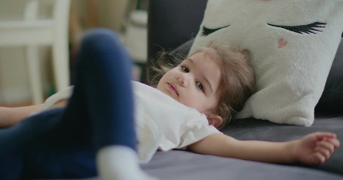 Portrait of a cute, funny little toddler girl at home on a normal day. Shot in 4K RAW on a cinema camera.